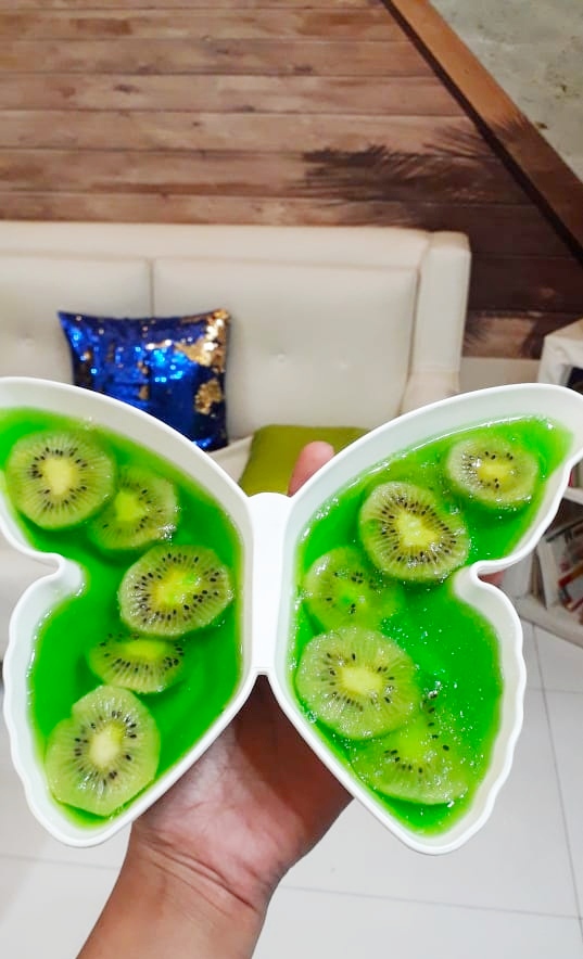 A bowl of fruit on a plate
Description automatically generated